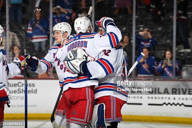 Jonathan Quick of the New York Rangers celebrates with teammate Barclay Goodrow after a 8-5 win against the Arizona Coyotes at Mullett Arena on March...