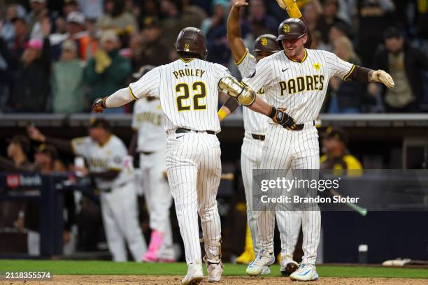 Graham Pauley of the San Diego Padres is congratulated by Jackson Merrill after hitting a three-run home run in the ninth inning during a game...