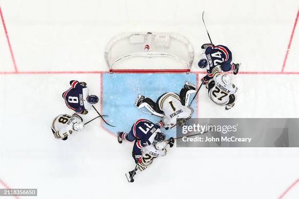 Jeremy Swayman of the Boston Bruins makes a save as Alex Ovechkin of the Washington Capitals looks for a rebound during a game at Capital One Arena...