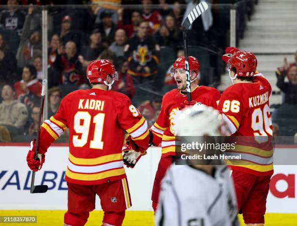 MacKenzie Weegar of the Calgary Flames celebrates his third period goal against the Los Angeles Kings with teammates at the Scotiabank Saddledome on...