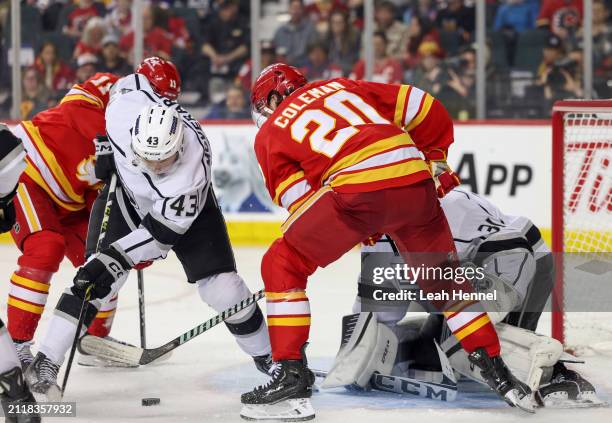 Jacob Moverare of the Los Angeles Kings and Blake Coleman of the Calgary Flames battle for the puck in front of David Rittich of the Los Angeles...