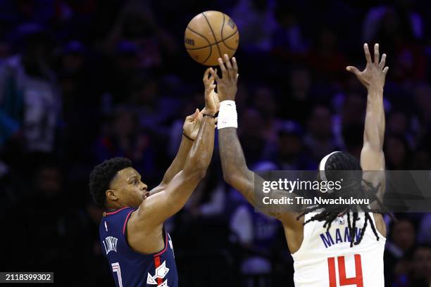 Kyle Lowry of the Philadelphia 76ers shoots past Terance Mann of the LA Clippers during the first quarter at the Wells Fargo Center on March 27, 2024...