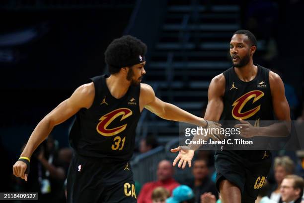 Jarrett Allen Evan Mobley of the Cleveland Cavaliers react during the first half of the game against the Charlotte Hornets at Spectrum Center on...