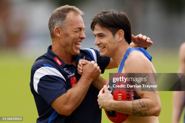 Alastair Clarkson, Senior Coach of the Kangaroos share a laugh with Zac Fisher of the Kangaroos during a North Melbourne Kangaroos AFL training...