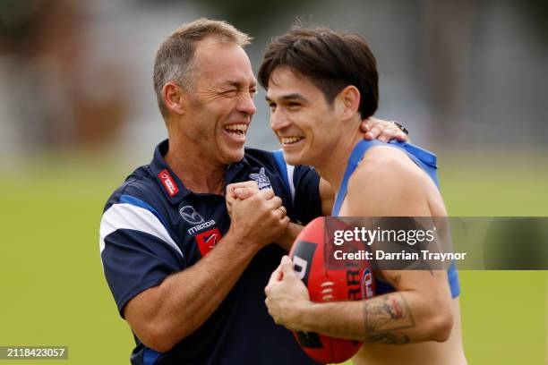 Alastair Clarkson, Senior Coach of the Kangaroos share a laugh with Zac Fisher of the Kangaroos during a North Melbourne Kangaroos AFL training...