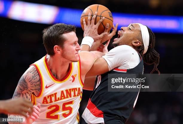 Moses Brown of the Portland Trail Blazers draws a foul from Garrison Mathews of the Atlanta Hawks during the second quarter at State Farm Arena on...