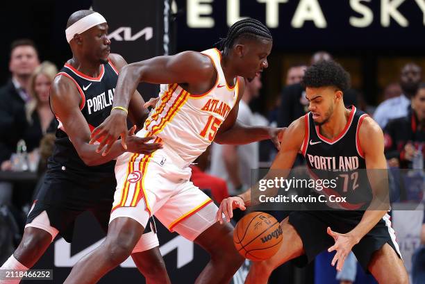 Duop Reath of the Portland Trail Blazers knocks the ball away from Clint Capela of the Atlanta Hawks into the hands of Rayan Rupert during the first...