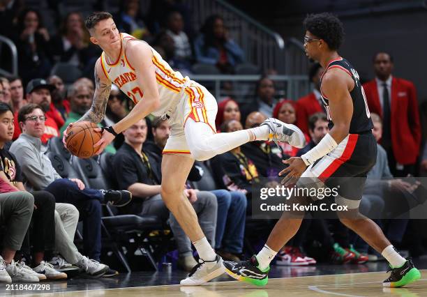 Vit Krejci of the Atlanta Hawks attempts to save a loose ball against Scoot Henderson of the Portland Trail Blazers during the first quarter at State...