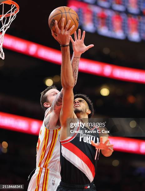 Rayan Rupert of the Portland Trail Blazers draws a foul as he drives against Garrison Mathews of the Atlanta Hawks during the first quarter at State...