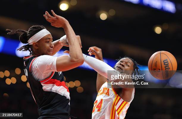 Moses Brown of the Portland Trail Blazers loses the ball as he drives against Bruno Fernando of the Atlanta Hawks during the first quarter at State...