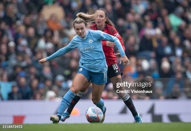 Lauren Hemp of Manchester City is challenged by Katie Zelem of Manchester United during the Barclays Women's Super League match between Manchester...