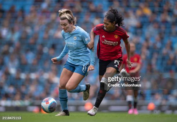Lauren Hemp of Manchester City is challenged by Jayde Riviere of Manchester United during the Barclays Women's Super League match between Manchester...
