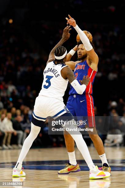 Cade Cunningham of the Detroit Pistons looks to pass against Jaden McDaniels of the Minnesota Timberwolves in the first quarter at Target Center on...