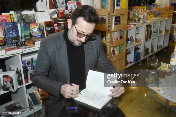 Actor/writer Michael Cohen signs his book "L’Attraction Du Desordr" at Librairie Libres Champs on March 27, 2024 in Paris, France.