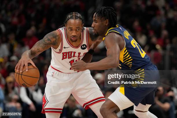 DeMar DeRozan of the Chicago Bulls dribbles the ball against Aaron Nesmith of the Indiana Pacers during the first half at the United Center on March...