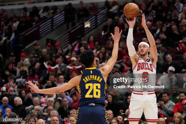 Alex Caruso of the Chicago Bulls shoots a three-point basket against Ben Sheppard of the Indiana Pacers during the first half at the United Center on...