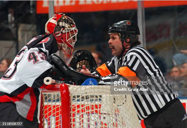 Martin Biron of the Buffalo Sabres has a chat with referee Bill McCreary against the Toronto Maple Leafs during NHL game action on March 6, 2004 at...