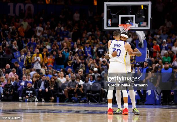 Stephen Curry and Gary Payton II of the Golden State Warriors reacts to winning a game against the Orlando Magic at Kia Center on March 27, 2024 in...