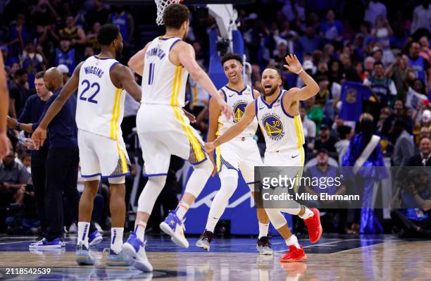Stephen Curry and Klay Thompson of the Golden State Warriors reacts to winning a game against the Orlando Magic at Kia Center on March 27, 2024 in...