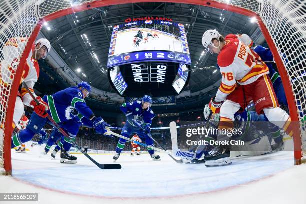 Casey DeSmith makes a save as Nikita Zadorov Ilya Mikheyev Sam Lafferty and Noah Juulsen of the Vancouver Canucks defend against Martin Pospisil and...