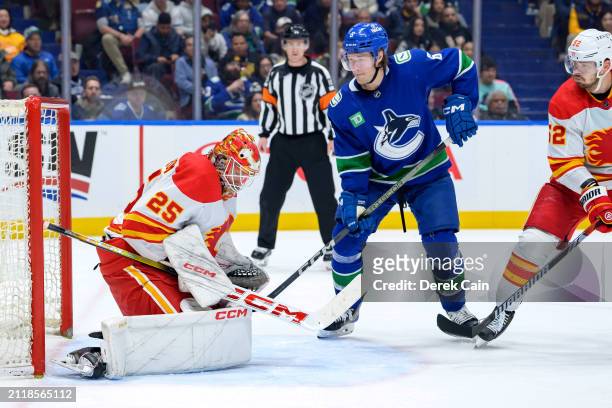 Brock Boeser of the Vancouver Canucks watches Jacob Markstrom of the Calgary Flames make a save during the third period of their NHL game at Rogers...