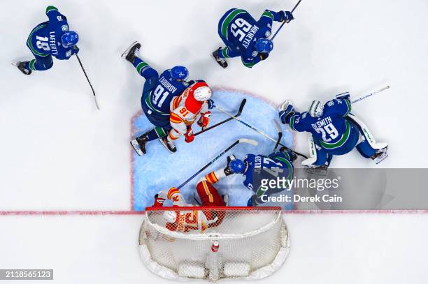 Casey DeSmith makes a save as Nikita Zadorov Ilya Mikheyev Sam Lafferty and Noah Juulsen of the Vancouver Canucks defend against Martin Pospisil and...