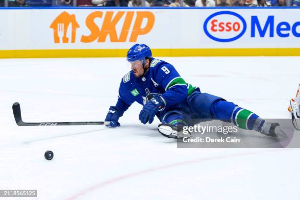 Miller of the Vancouver Canucks is tripped during the third period of their NHL game against the Calgary Flames at Rogers Arena on March 23, 2024 in...