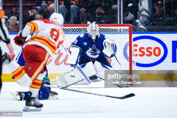 Casey DeSmith of the Vancouver Canucks tracks a shot by Brayden Pachal of the Calgary Flames during the third period of their NHL game at Rogers...