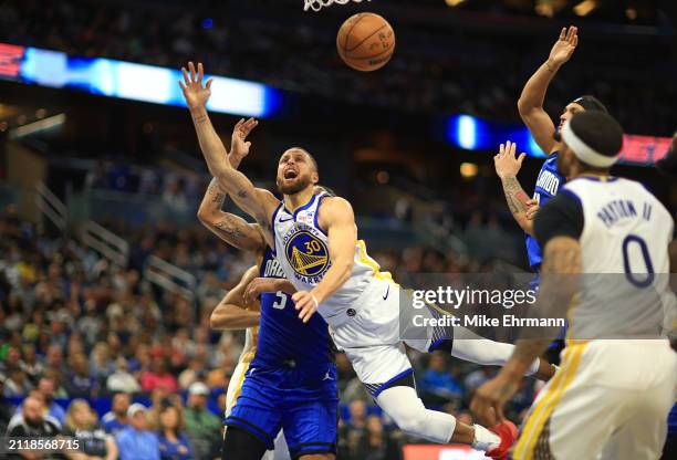 Stephen Curry of the Golden State Warriors drives to the basket during a game against the Orlando Magic at Kia Center on March 27, 2024 in Orlando,...