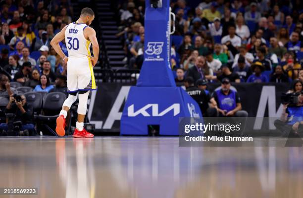 Stephen Curry of the Golden State Warriors looks on during a game against the Orlando Magic at Kia Center on March 27, 2024 in Orlando, Florida. NOTE...