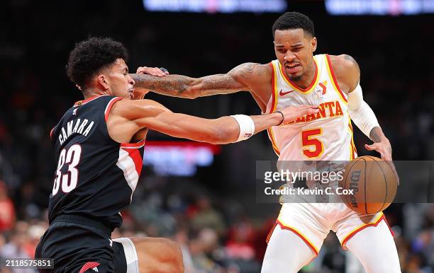Dejounte Murray of the Atlanta Hawks attempts a shot against Toumani Camara of the Portland Trail Blazers during the fourth quarter at State Farm...