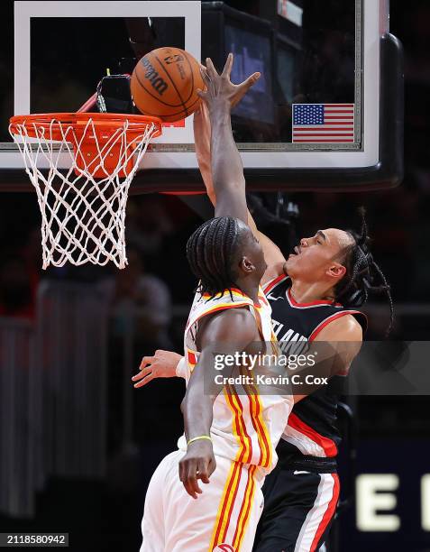 Dalano Banton of the Portland Trail Blazers dunks against Clint Capela of the Atlanta Hawks during the fourth quarter at State Farm Arena on March...