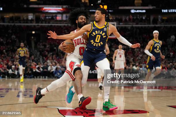 Coby White of the Chicago Bulls dribbles the ball against Tyrese Haliburton of the Indiana Pacers during the first half at the United Center on March...