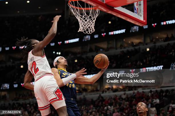 Andrew Nembhard of the Indiana Pacers shoots the ball against Ayo Dosunmu of the Chicago Bulls during the second half at the United Center on March...