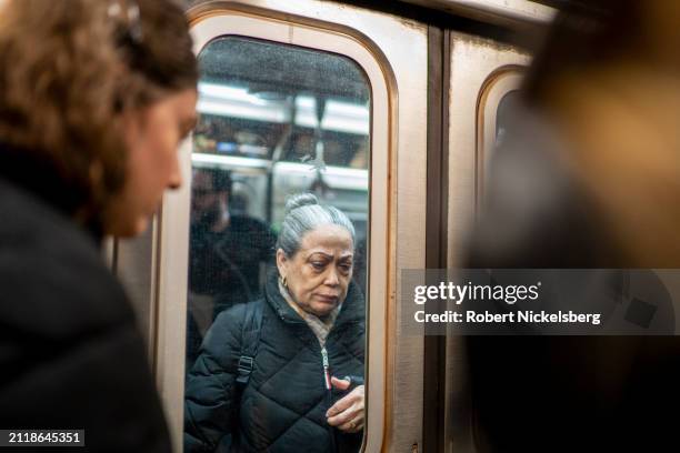 Passengers prepare to exit and board a subway car during afternoon rush hour on March 27, 2024 in New York City. New York City's subway daily...