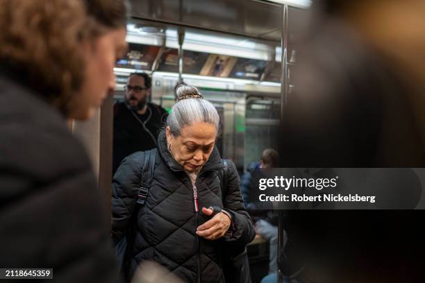 Passengers prepare to exit and board a subway car during afternoon rush hour on March 27, 2024 in New York City. New York City's subway daily...