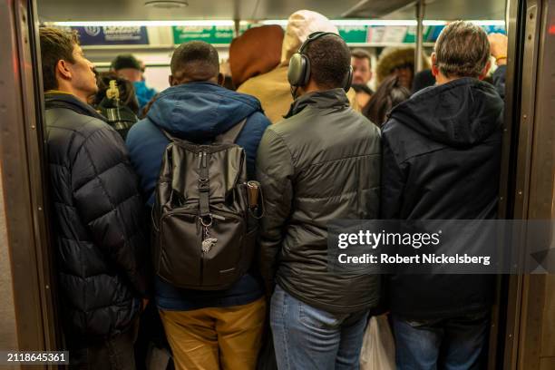 Subway passengers crowd into a car during afternoon rush hour on March 27, 2024 in New York City. New York City's subway daily ridership is...