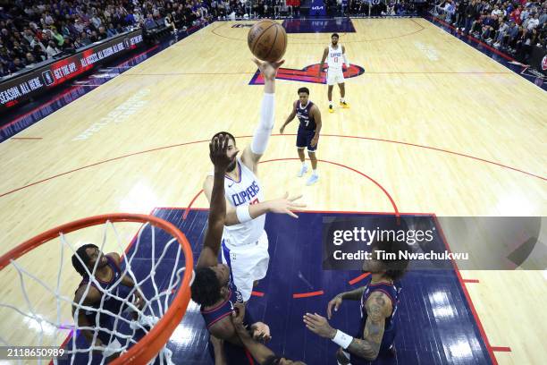 Ivica Zubac of the LA Clippers shoots over Mo Bamba of the Philadelphia 76ers during the first quarter at the Wells Fargo Center on March 27, 2024 in...