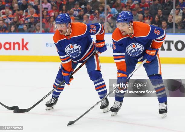 Sam Carrick and Cody Ceci of the Edmonton Oilers set for a face off in the first period against the Montreal Canadiens on March 19, 2024 at Rogers...