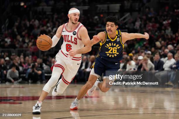 Alex Caruso of the Chicago Bulls dribbles the ball against Ben Sheppard of the Indiana Pacers during the first half at the United Center on March 27,...
