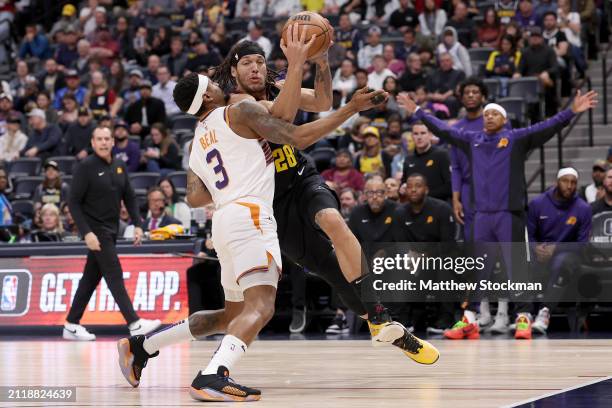 Aaron Gordon of the Denver Nuggets drives against Bradley Beal of the Phoenix Suns during the first quarter at Ball Arena on March 27, 2024 in...