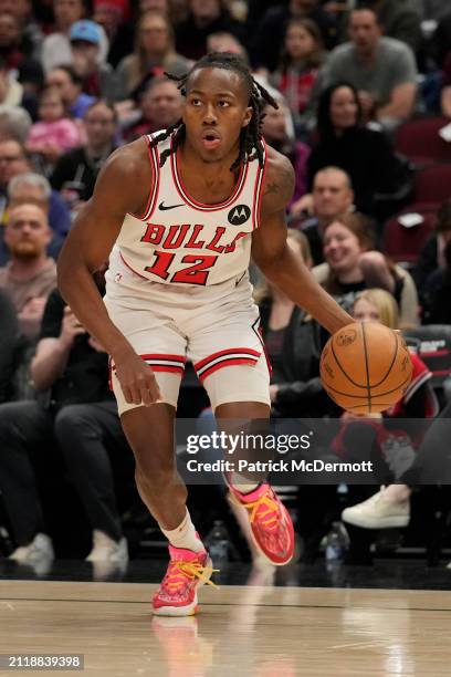 Ayo Dosunmu of the Chicago Bulls dribbles the ball during the first half against the Indiana Pacers at the United Center on March 27, 2024 in...