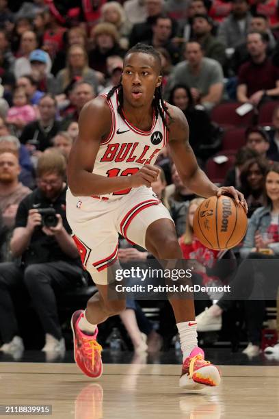 Ayo Dosunmu of the Chicago Bulls dribbles the ball during the first half against the Indiana Pacers at the United Center on March 27, 2024 in...