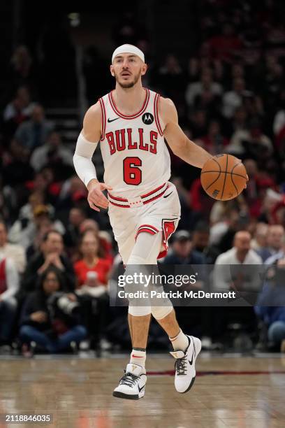 Alex Caruso of the Chicago Bulls dribbles the ball during the first half against the Indiana Pacers at the United Center on March 27, 2024 in...