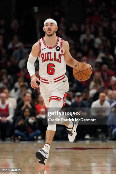 Alex Caruso of the Chicago Bulls dribbles the ball during the first half against the Indiana Pacers at the United Center on March 27, 2024 in...