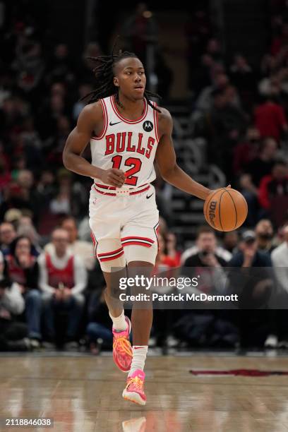 Ayo Dosunmu of the Chicago Bulls dribbles the ball during the first half against the Indiana Pacers at the United Center on March 27, 2024 in...