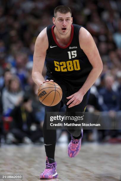 Nikola Jokic of the Denver Nuggets brings the ball down the court against the Phoenix Suns during the third quarter at Ball Arena on March 27, 2024...