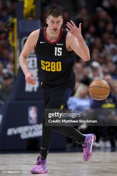 Nikola Jokic of the Denver Nuggets brings the ball down the court against the Phoenix Suns during the third quarter at Ball Arena on March 27, 2024...