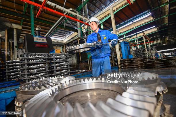 Worker is working at an auto gear manufacturing enterprise in the Qingzhou Economic Development Zone, in Qingzhou, China, on March 31, 2024. On the...