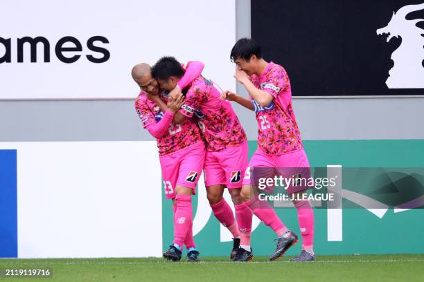 Yuji Ono of Sagan Tosu celebrates with teammates Yutaka Yoshida and An Yong-woo after scoring the team's second goal during the J.League J1 match...